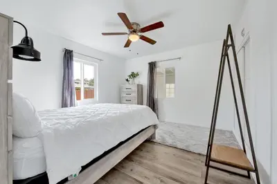 a bedroom with a bed and a ceiling fan at Modern Peaceful Private Oasis Near The Beach in Los Angeles