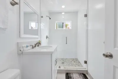 a white bathroom with a sink and a shower at Modern Peaceful Private Oasis Near The Beach in Los Angeles