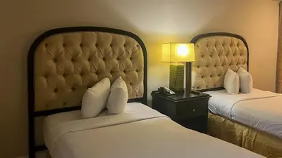 a hotel room with two beds and a lamp at Motel 6 Victorville Green Tree Bvld in Victorville