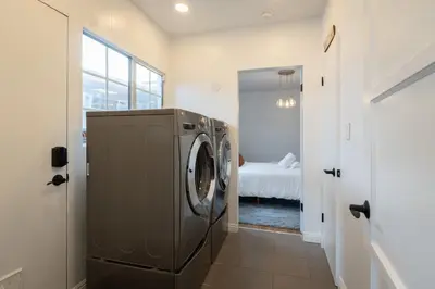 a washing machine in a hallway with a bedroom at Angel&Rose Universal Hollywood Heated Pool House King Bed in Los Angeles