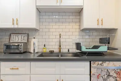a kitchen with white cabinets and a sink at Angel&Rose Universal Hollywood Heated Pool House King Bed in Los Angeles