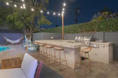 a patio with a bar with chairs and a table at Angel&Rose Universal Hollywood Heated Pool House King Bed in Los Angeles