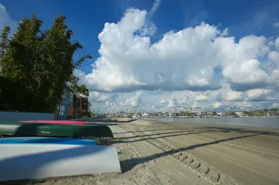 a view of a beach with a cloudy sky and water at Peninsula Hideaway Apartment • Alamitos Bay in Long Beach