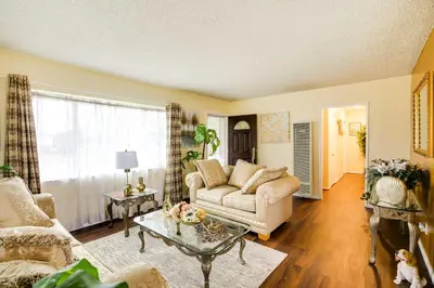 a living room with a couch and a table at Centrally Located Compton Retreat Patio and Grills in Compton