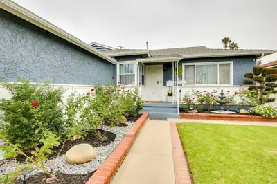 a house with flowers in the front yard at Centrally Located Compton Retreat Patio and Grills in Compton
