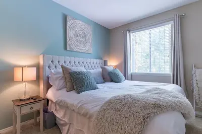 a bedroom with a large white bed with a window at Modern King Suite Deluxe Living Cali in Santa Clarita