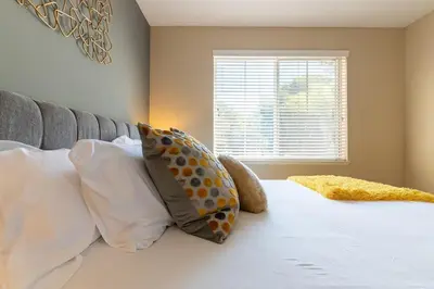 a bedroom with a bed with pillows and a window at Saints 2BDRM King Suite Deluxe Living Cali in Santa Clarita