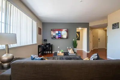 a living room with a couch and a table at Saints 2BDRM King Suite Deluxe Living Cali in Santa Clarita