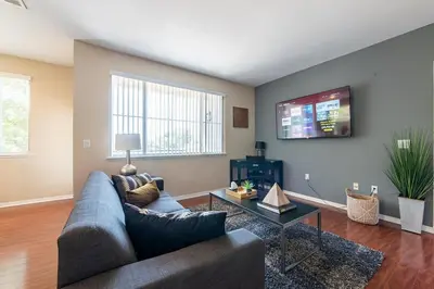 a living room with a couch and a tv at Saints 2BDRM King Suite Deluxe Living Cali in Santa Clarita