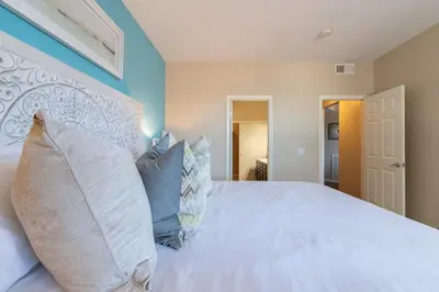 a bedroom with a large white bed with pillows at Sky Luxury 2BDRM Suite Deluxe Living Cali in Santa Clarita