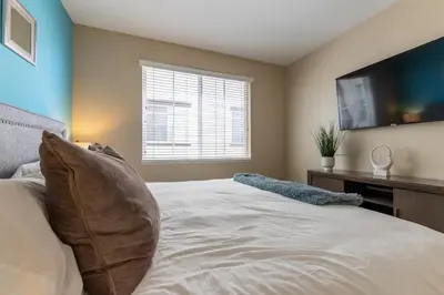 a bedroom with a large bed with a flat screen tv at Sky Luxury 2BDRM Suite Deluxe Living Cali in Santa Clarita