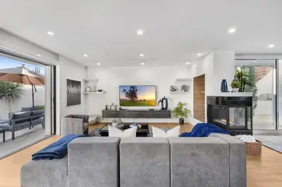 a living room with a couch and a fireplace at Lindenhurst in Los Angeles
