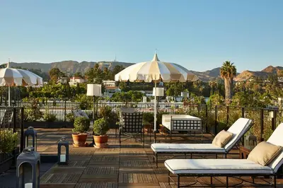 a patio with chairs and tables and umbrellas at Cozy Studio With Franklin Village View - 30 Day Minimum Stay in Los Angeles