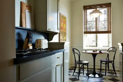 a kitchen with a table and chairs next to a counter at Cozy Studio With Franklin Village View - 30 Day Minimum Stay in Los Angeles
