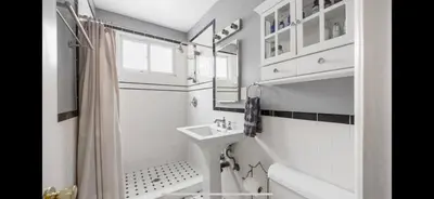 a white bathroom with a sink and a shower at Chic Venice Beach Bungalow Steps from the Canals & Beach in Los Angeles