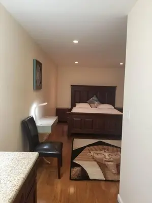 a bedroom with a bed and a chair and a desk at Beautiful Spacious 2 Bedroom, 2 Bathroom Condo in Long Beach
