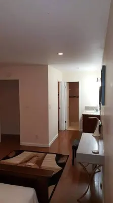 a room with a bed and a table in a room at Beautiful Spacious 2 Bedroom, 2 Bathroom Condo in Long Beach