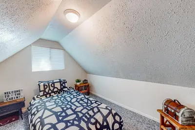 a bedroom with a bed in a attic at El Sueńo in Crestline