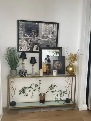 a shelf with pictures and plants on top of it at Your Penthouse Ocean view with City lights and Queen Mary too in Long Beach