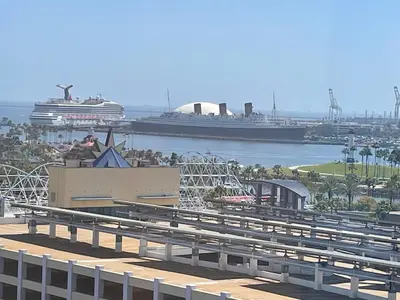 a cruise ship in a harbor with a cruise ship at Your Penthouse Ocean view with City lights and Queen Mary too in Long Beach