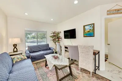 a living room with a blue couch and a table at Anaheim Hills Retreat - 17 Mi to Disneyland! in Anaheim