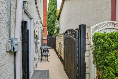 an alley with a table and a fence at Anaheim Hills Retreat - 17 Mi to Disneyland! in Anaheim