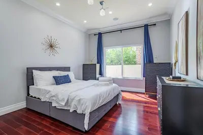 a bedroom with a large bed and a window at Regal 4 bed with hot tub close to Universal sleeps 15 in Los Angeles
