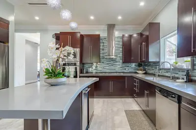 a kitchen with purple cabinets and a large island at Regal 4 bed with hot tub close to Universal sleeps 15 in Los Angeles