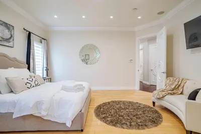 a white bedroom with a bed and a couch at Regal 4 bed with hot tub close to Universal sleeps 15 in Los Angeles