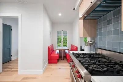 a kitchen with red chairs and a stove at Chic 3BR Oasis in Studio City:Toluca Lake Adjacent in Los Angeles