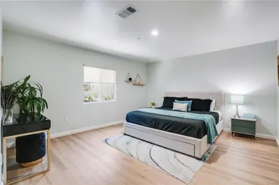 a white bedroom with a bed and a tv at Salt Water Pool Over Look Rocky Mountain View in Sierra Madre