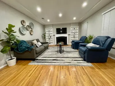a living room with two couches and a fireplace at 5 Mins Walk To Oldtown Monrovia Cozy 4 Br Home in Monrovia