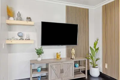 a living room with a flat screen tv on a wall at Central Location Family Size Home in Temple City