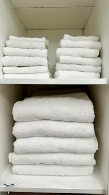 a closet filled with white towels on a shelf at Central Location Family Size Home in Temple City