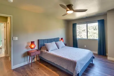 a bedroom with a bed and a ceiling fan at Running Springs Cabin with Spacious Deck and Hot Tub! in Running Springs
