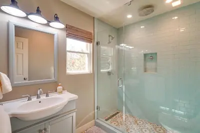 a bathroom with a sink and a glass shower at Running Springs Cabin with Spacious Deck and Hot Tub! in Running Springs
