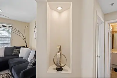a living room with a couch and a lamp at Luxury 2BR/2BA! 5 MIN to Disney! in Anaheim