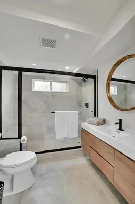 a bathroom with a toilet and a sink and a mirror at Brand new Chic-Nest in Prime Location in Sherman Oaks