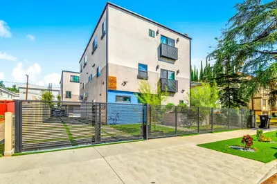 an apartment building with a fence in front of it at Brand new Chic-Nest in Prime Location in Sherman Oaks