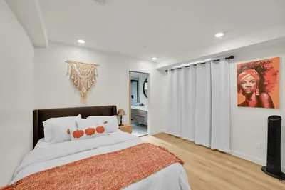 a bedroom with a bed and a painting on the wall at Brand new Chic-Nest in Prime Location in Sherman Oaks