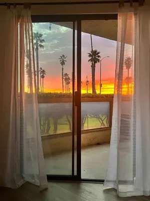 a window with a view of a sunset at Beachfront Paradise in Port Hueneme