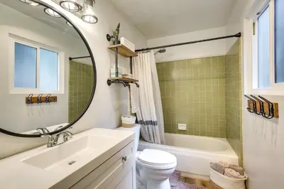 a bathroom with a sink and a tub and a toilet at Cozy and Chic Lake Arrowhead Cabin with Deck! in Lake Arrowhead