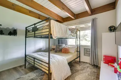 a bedroom with two bunk beds in a room at Cozy and Chic Lake Arrowhead Cabin with Deck! in Lake Arrowhead