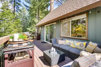 a patio with a couch and a grill on a deck at Cozy and Chic Lake Arrowhead Cabin with Deck! in Lake Arrowhead