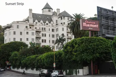 a large white building with a sign in front of it at Hollywood Guesthouse in Los Angeles