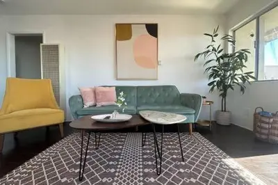 a living room with a green couch and a coffee table at Ocean View 1 Bedroom Manhattan Beach in Manhattan Beach
