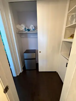 a small room with a white door and a closet at Ocean View Studio Manhattan Beach in Manhattan Beach