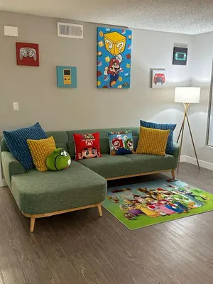 a living room with a green couch and a rug at Hollywood Apartments Mario & No Themed With Pool FREE parking and WIFI in Los Angeles