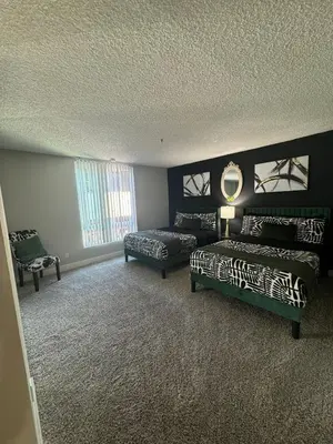 a bedroom with two beds and a mirror on the wall at Hollywood Apartments Mario & No Themed With Pool FREE parking and WIFI in Los Angeles