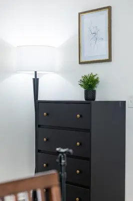 a black dresser with a plant on top of it at 8 Beds Home with 4 Car Parking Space - Near DTLB in Long Beach